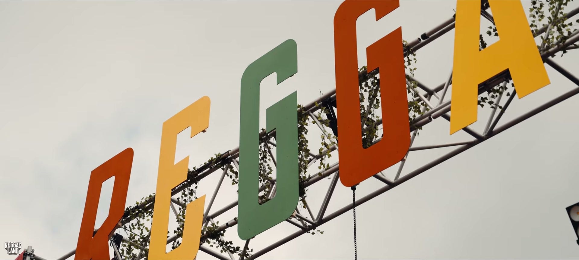 Giant coloured letters spelling Reggae on the festival gantry at Reggae Land, Milton Keynes