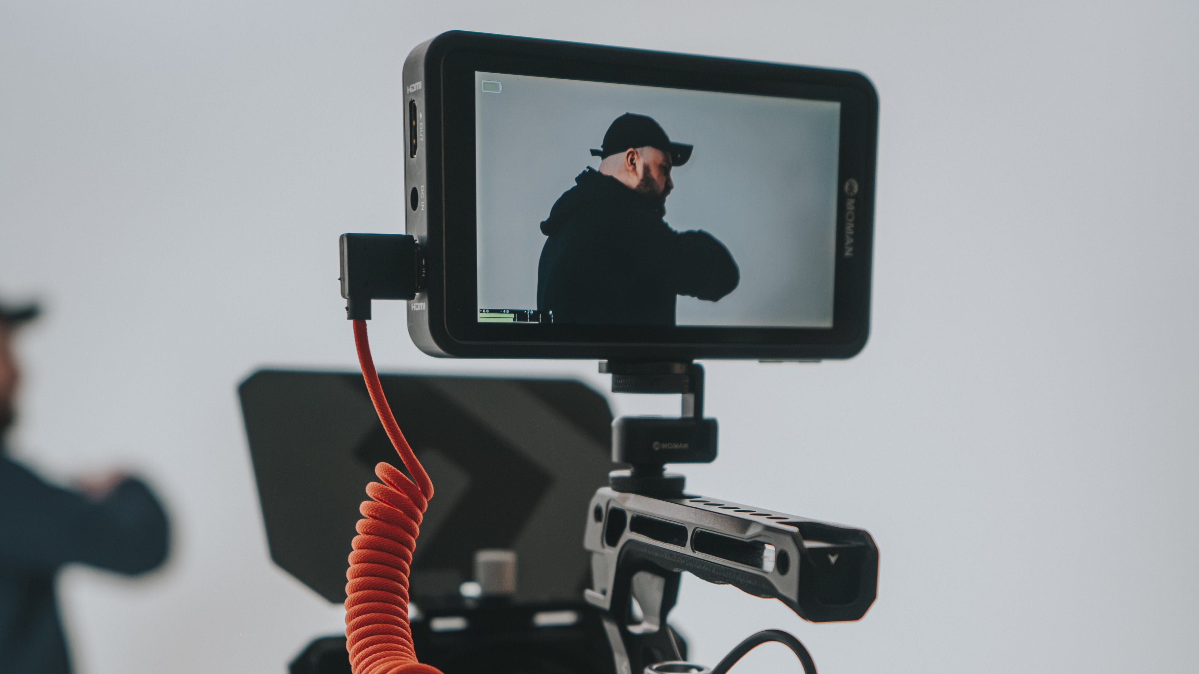 A rigged cinema camera, its monitor framing a presenter in the Flexxed studio